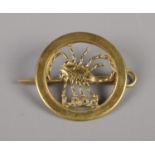 A WWII Long Range Desert Group cap badge with pin.