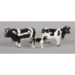 A Beswick Friesian family comprised of bull, cow and calf.