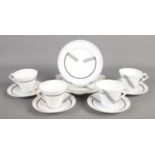 A Foley China Art Deco part tea service, containing cups, saucers and sandwich plate. Base of one