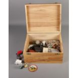 A wooden box of collectables including costume jewellery, diecast cars, silver plate, etc.