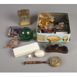 A tin of collectables include Wedgwood, glass paperweight, Smiths Bed pan clock, marble egg, etc.