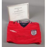 An England football shirt signed by Michael Owen, with certificate of authenticity.