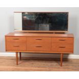 A two piece retro vintage teak bedroom set including wardrobe with semi-fitted interior and dressing