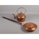 A Victorian copper kettle along with a copper bed warming pan with Yorkshire rose decoration.