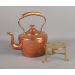 A 19th century copper kettle along with decorative brass stand.