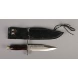 A Buck, USA, bowie knife with polished hardwood handle. In black leather sheath. CANNOT POST