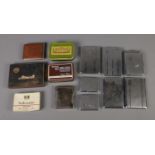 A collection of tobacco tins and chrome cigarette cases most with engine turned decoration and one