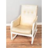 A painted white leather rocking chair.