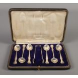 A cased set of silver coffee spoons and sugar tongs. Assayed for Glasgow 1906 & 1907 by R & W
