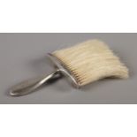 A silver handled clothes brush, assayed for Birmingham, 1905 by Henry Charles Freeman. Total weight: