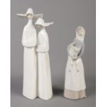 Two Lladro ceramic figure groups, featuring two nuns and lady with sheep. Tallest: 34cm. One ear