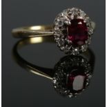 An 18ct Gold and Platinum, Ruby and Diamond cluster ring. Size K. Total weight: 3.1g.