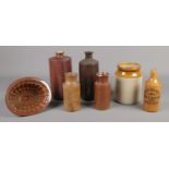 A collection of stoneware items, to include jelly mould, storage jar and a series of bottles.