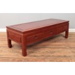 A Chinese carved hardwood coffee table. Height 41cm, Width 127cm, Depth 51cm.