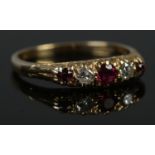 An 18ct Gold, ruby and diamond five stone ring. Size K. Total weight: 2.6g.