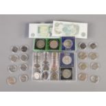 A collection of British coins and banknotes including commemorative 50p's, Â£2 coins, crowns, etc.
