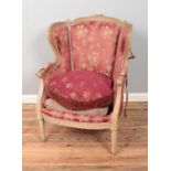 An upholstered carved pitch pine chair. Upholstery in need of repair.