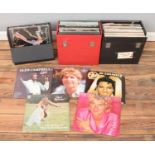 Three carry cases of assorted records. To include Rod Stewart, Elvis, Boxcar Willie and Glen