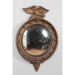 An Atsonea Regency style convex mirror surmounted with an eagle.