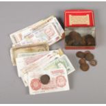 A collection of coins and banknotes including Portuguese, British and German examples.