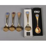 Four Georg Jensen silver gilt year spoons featuring floral enamel decoration. Includes years 1972,