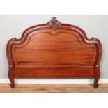 A Victorian carved mahogany headboard.