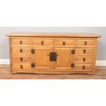 An Asian hardwood low sideboard. Height 57cm, Width 131cm, Depth 43cm.