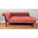 A carved mahogany chaise longue raised on castors.