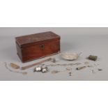 A mahogany box containing an assortment of white metal oddments, including two fob watches,