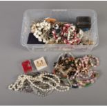 A box of assorted costume jewellery to include necklaces, earrings, etc.