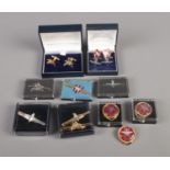 A collection of military themed cufflinks, tie slides, scarf rings, pins, etc.