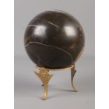 A marble sphere on gilt stand. Approx. height 22cm.
