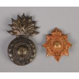 A Gibraltar Royal Marine Artillery helmet plate in the form of a flaming grenade and cap badge.