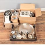 Three boxes of metal kitchen wares including cutlery, colander, trays, etc.