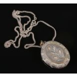 A Victorian white metal locket on silver chain. Total weight 21.69g.