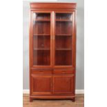 A Chinese hardwood glazed cabinet with drawer and cupboard base. Height 198.5cm, Width 92cm, Depth