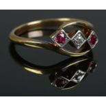 An 18ct Gold and Platinum three stone Ruby and Diamond twist ring. Size U. Total weight: 4.6g