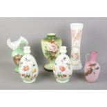 A collection of Victorian coloured glassware vases including painted floral examples.