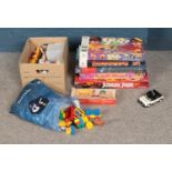 A collection of board games and Playmobil toys including Jurassic Park, Battle of Britain, Grape