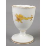 A Meissen porcelain egg cup decorated with dragons.