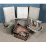 A collection of metal trays and buckets including Eltex green house heater.