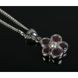 A 14ct White Gold ruby and diamond floral pendant on 9ct White Gold chain. Total weight: 3.8g
