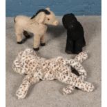 Three soft toys including Merry Thought snow leopard and Donkey, possibly from a rocking base.