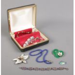 A hinged jewellery box containing various items of modern jewellery; including Lapiz Lazuli beads,