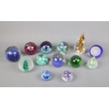 A collection of mostly Caithness glass paperweights including Flowers of Scotland and