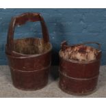 Two wooden metal bound well buckets.