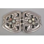 A Danish silver belt buckle, set with a trio of polished stones to each side. Stamped 826 SSJ to