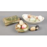 A collection of decorative hardstone eggs along with trinket dish and box.
