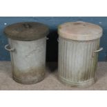 Two lidded galvanised metal bins.