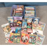 Two boxes of sporting annuals and books. Includes football, cricket, boxing, etc.